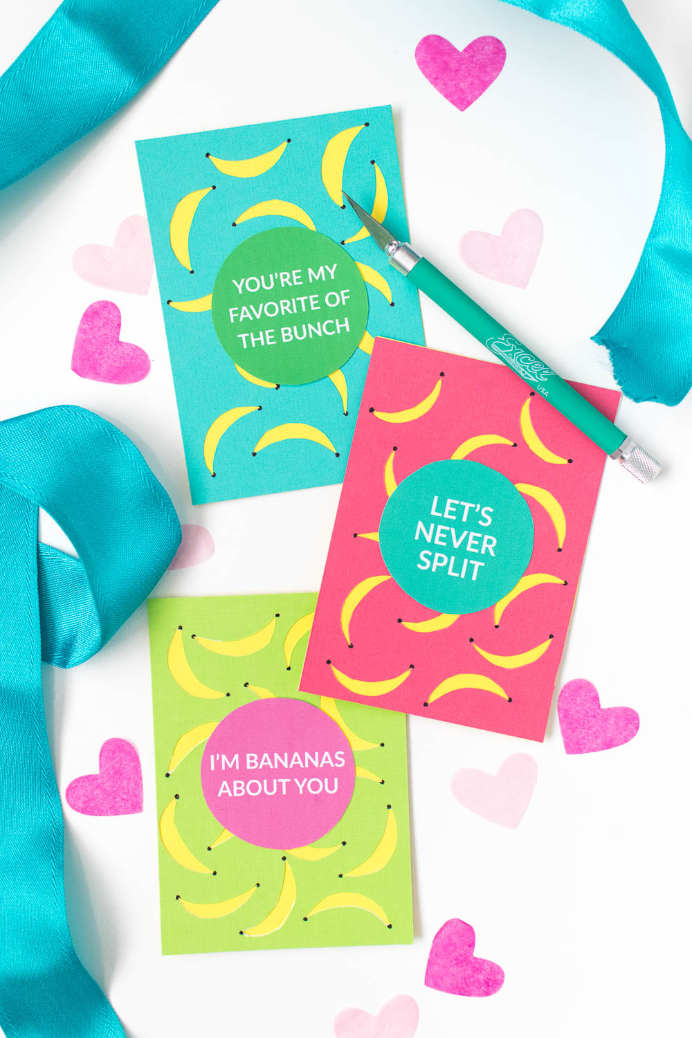 Three brightly coloured valentines with banana puns written