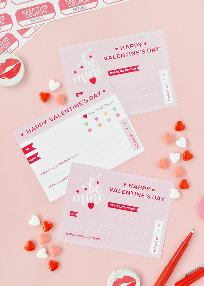 Light pink background with red and white heart candies and post card sized valentines