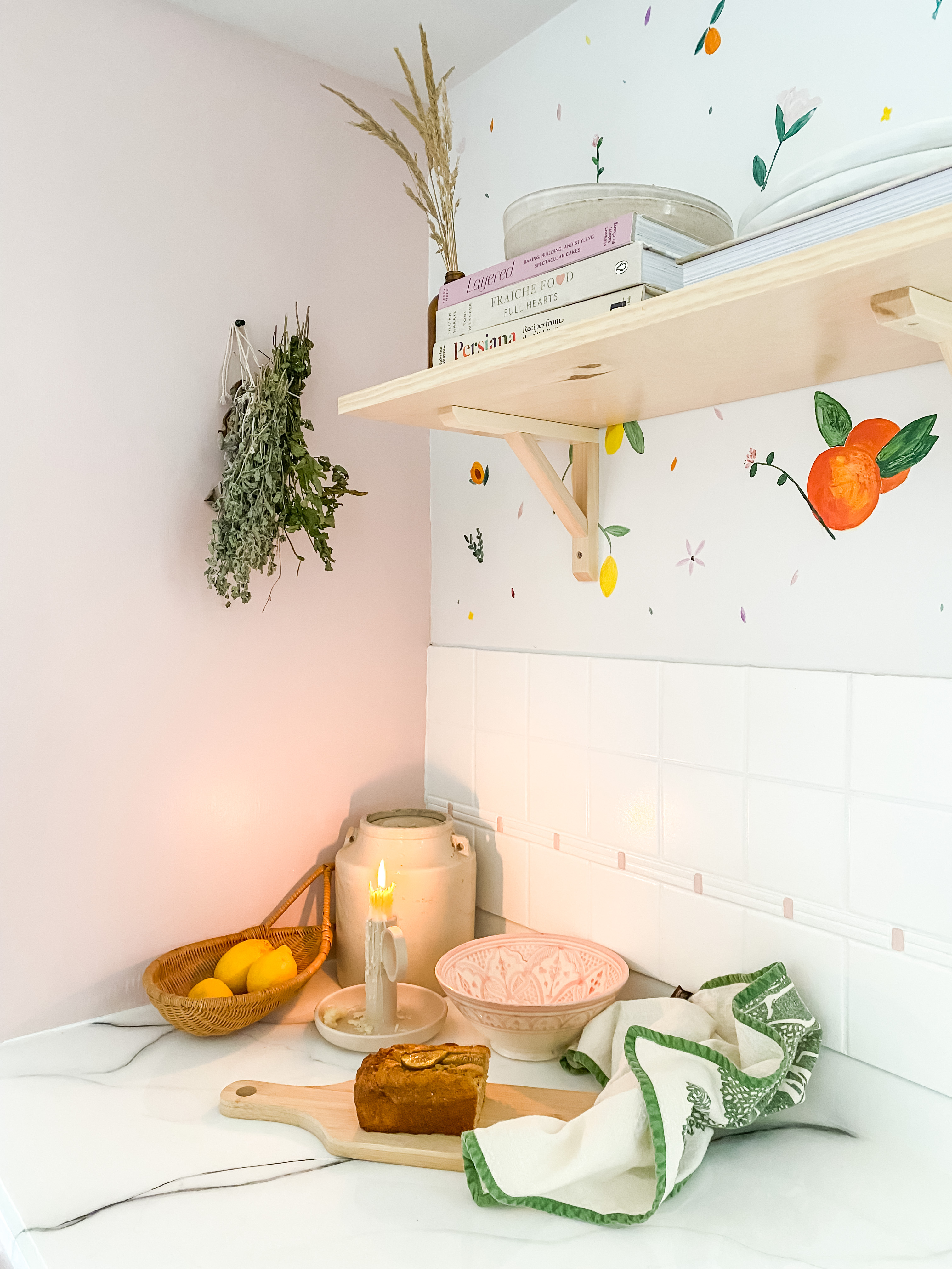 Pink and white kitchen with candle lit